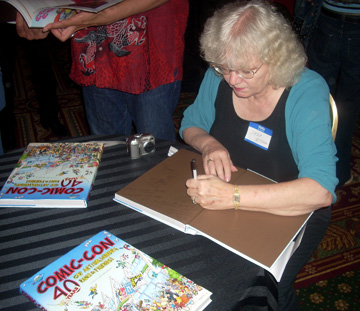 Jackie Estrada signing books at the 2009 Comic-Con 40th-anniversary party.